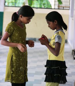 Practicing their sewing skills